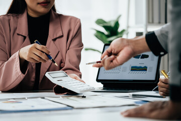 Close up of hands teamwork business group are meeting working calculate and brainstorming about business financial and marketing on paperwork and presentation.