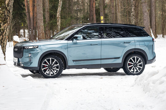 Moscow. Russia - February 24: blue Chinese SUV Chery Jaecoo J7 in forest