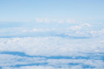 background image: view of clouds from above floating across the blue sky below