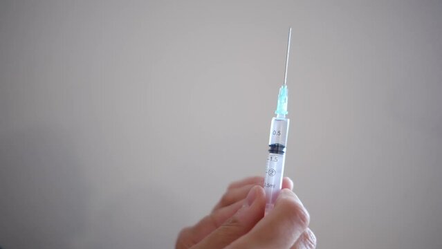 Woman injecting progesterone into her belly for fertility treatment, focusing on assisted reproduction, gynecology, and reproduction