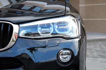 Obraz premium Close-up front headlight. Headlight premium car. Digital LED Light Technology. HD Matrix LED. Adaptive light system. Led, Laser and Matrix headlight. 