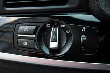 Light control panel in a modern passenger car. Car light switch. Dashboard for switching on the...