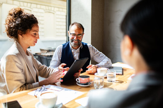 Business meeting in a cafe with diverse professionals