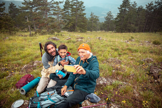 Three generation family selfie during hiking adventure in the mountains