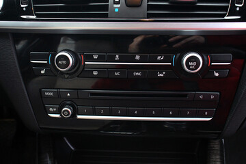 Premium car climate control. Close-up detail with the air conditioning panel inside a Lux car....