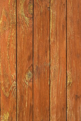 Naklejka premium Texture of an old cracked wall painted in orange made of wooden panels as a rustic natural background