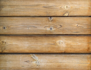 Texture of an old cracked wall made of wooden panels with multiple knots as a rustic natural background