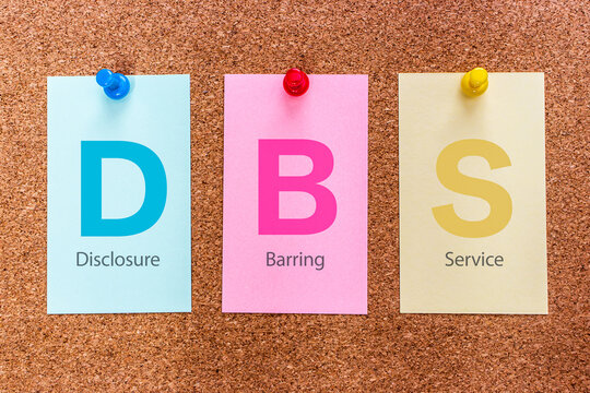 Conceptual 3 letters keyword DBS (Disclosure and Barring Service), on multicolored stickers attached to a cork board.