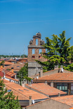 Traditional roofs and Belfry tower of San jeronimo monastery. White stork (Ciconia ciconia) nest on top. Avila, Spain.
