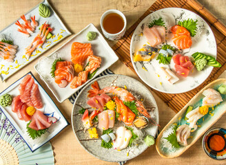 Assorted Comprehensive Sashimi with Dory sashimi, salmon sashimi, Tuna fish, swordfish, Sweet shrimp served in plate isolated on napkin top view on wooden background of Japanese food