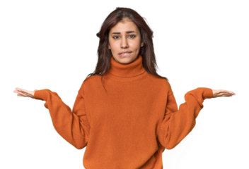 Middle Eastern woman in studio confused and doubtful shrugging shoulders to hold a copy space.