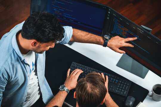 IT developers discussing online software development information on pc screen, creating program coding for latest version application on website. Concept of brainstorming firmware updated. Sellable.