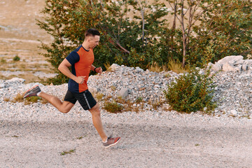 Determined Athlete Running Through Rugged Mountain Terrain at Sunrise.