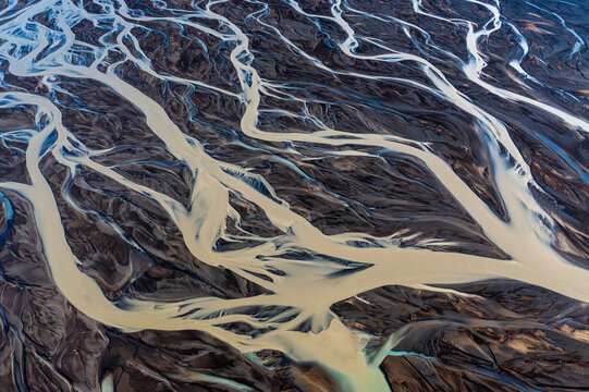 Drone view of river streams meandering on glacier riverbed