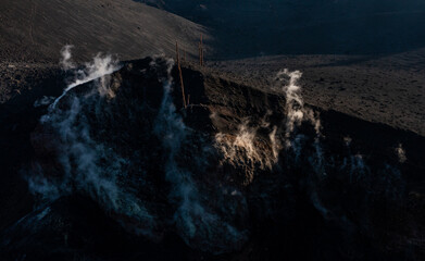 Volcanic eruption on mountainous terrain at dusk