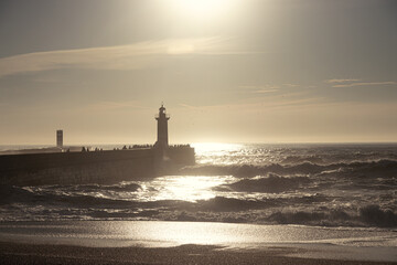 Fototapeta premium Sunset in the ocean by the lighthouse