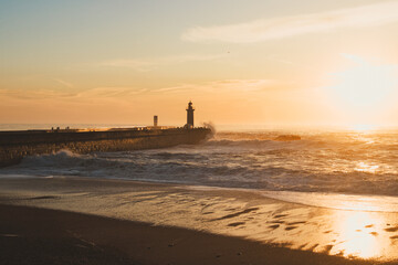 Fototapeta premium Sunset in the ocean by the lighthouse