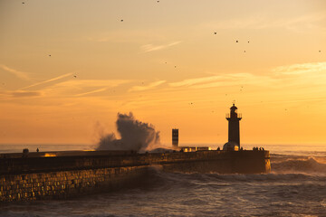 Sunset in the ocean by the lighthouse