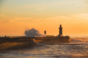 Sunset in the ocean by the lighthouse
