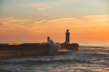 Sunset in the ocean by the lighthouse
