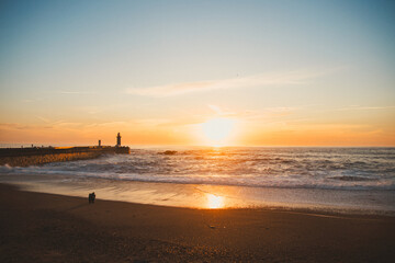 Sunset in the ocean by the lighthouse