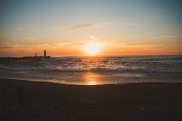 Sunset in the ocean by the lighthouse