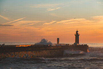Sunset in the ocean by the lighthouse