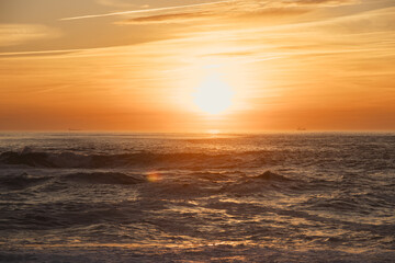 Sunset in the ocean by the lighthouse