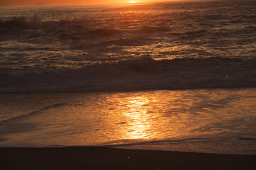 Sunset in the ocean by the lighthouse