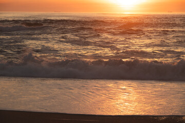 Sunset in the ocean by the lighthouse