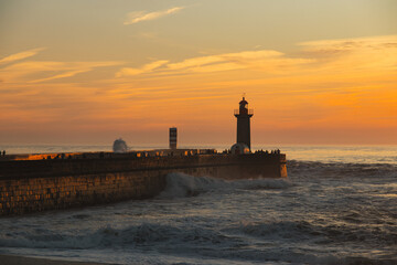 Sunset in the ocean by the lighthouse