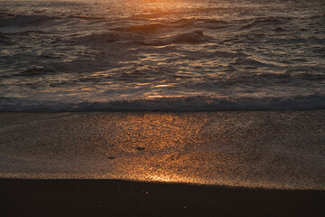 Sunset in the ocean by the lighthouse