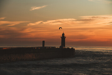 Sunset in the ocean by the lighthouse