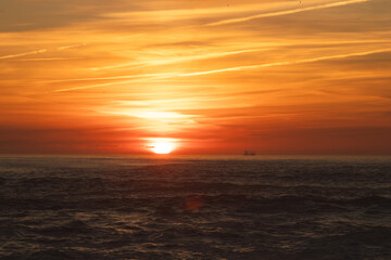 Sunset in the ocean by the lighthouse
