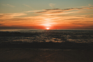 Sunset in the ocean by the lighthouse