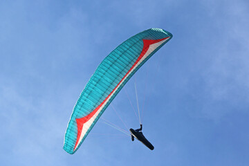  Paraglider flying in a blue sky