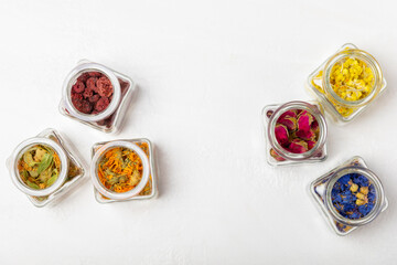 Assortment of dry herbal and berry tea on a wooden background. Tea party concept. medicinal herbs. Healing herbs.Alternative medicine.Linden, calendula, cornflowers, marigold, tansy, tea rose.