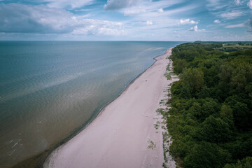 the deserted beach of the Baltic Sea under a cloudy sky