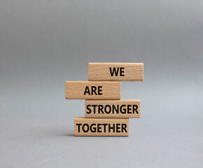We are stronger together symbol. Wooden blocks with words We are stronger together. Beautiful grey...