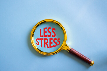 Less stress symbol. Magnifying glass with words Less stress. Beautiful blue background. Healthcare and Less stress concept. Copy space.