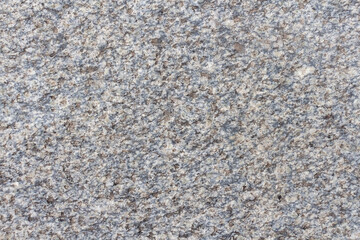 Abstract textured grey granite background. Close-up view of gray grainy stone surface. Soft focus. Copy space for your text or decoration. Real stone backdrop. Construction material theme. 