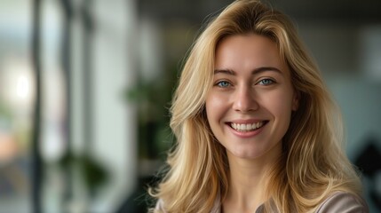 Obraz premium Portrait of a Friendly Blonde Woman Smiling Indoors with Bright Natural Light