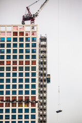 Sky scraper under construction with crane on top