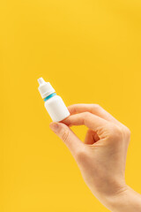 White plastic medical vial in a hand