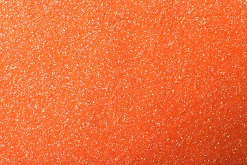 Beautiful shiny orange glitter as background, closeup