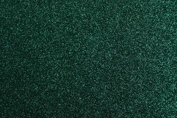 Shiny dark green glitter as background, closeup