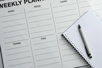 Timetable. Planner, notebook and pen on grey table, top view