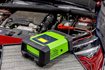 To charge faulty car electrical power for starting, energy to the battery or dead battery. Add equipment tool such as portable charger, positive negative clamp, red black cable wire.