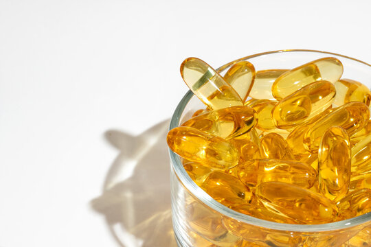 Close-up view of omega 3 capsules in a glass bowl