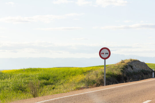 Scenic road landscape with a no overtaking sign